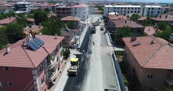 Asphalt road construction. Aerial view on the road rollers working on the new road construction site