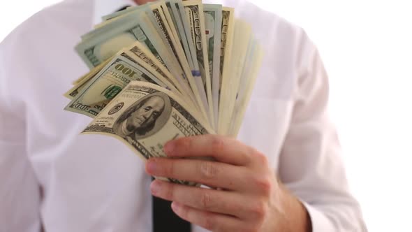 A Man In A White Shirt And Tie Holds A Wad Of Money, Dollars. Shows Money.