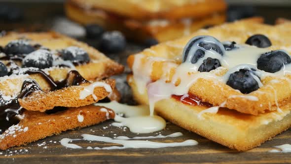 Belgian Blueberry Waffles Topped with Chocolate Topping and Condensed Milk