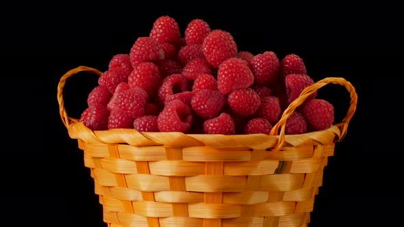 Fresh tasty raspberry in the basket turns on plate