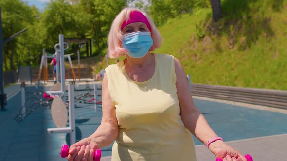 Senior Woman Grandmother Doing Training Weightlifting Exercising with Dumbbells on Park Playground alt