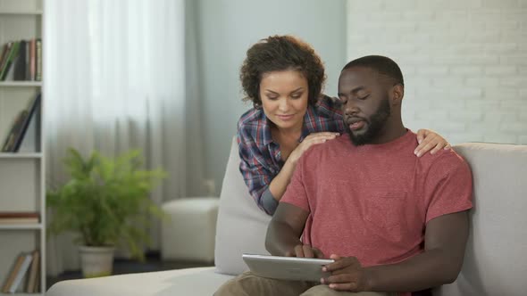 Happy Married Couple Planning Trip Abroad, Choosing Hotels and Airlines Online alt