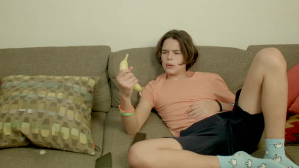 Funny forgetful teenager takes call on banana