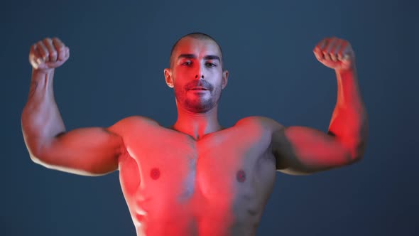 Male Fitness Model Showing Muscular Arms, Chest and Shoulders, Posing for Photo Session alt