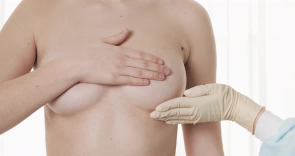 Doctor Checking Woman's Breast at Hospital. Breast Cancer Prevention. Close Up. alt