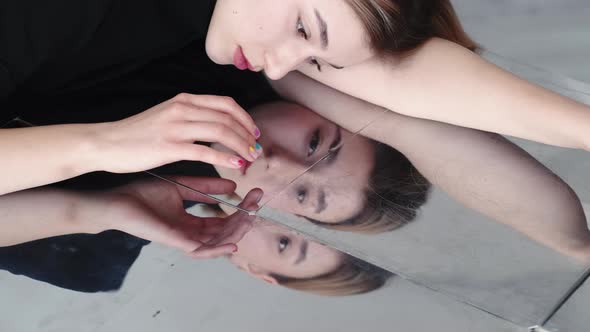 Sad Woman Melancholy Face in Distressed Mirror alt