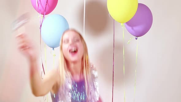 Blonde woman having fun in photo booth alt