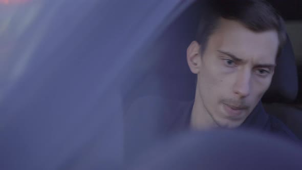 a Young Skinny European Guy Sits in the Driver's Seat alt