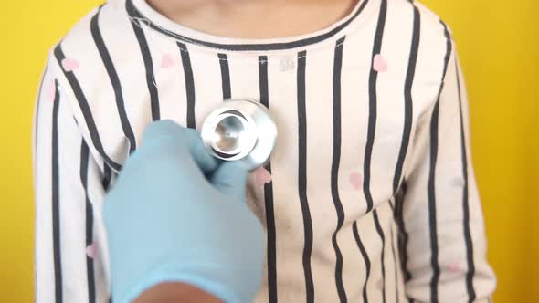 Doctor Using a Stethoscope Checking Child Body Close Up alt