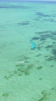 Vertical Video Kitesurfing Near the Shore of Zanzibar Tanzania alt