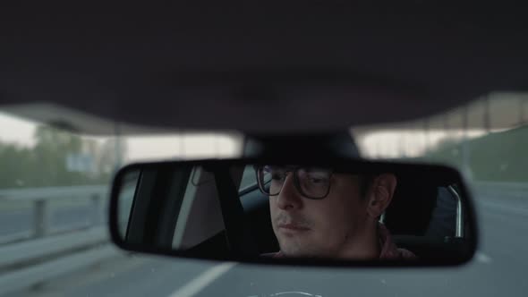 Driver in Car in Mirror Face alt