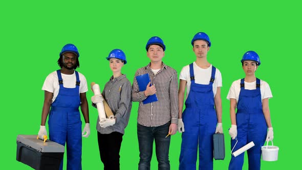 Group of Construction Workers with Their Instruments Smiling on Camera on a Green Screen Chroma Key
