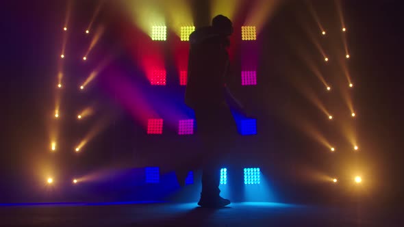 Professional Young Hip-hop Dancer, Dancing in Dark Studio in the Green and Yellow Fog. Hip Hop alt