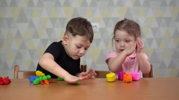 Little Kids Friends Girl and Boy Molding of Plasticine in Nursery