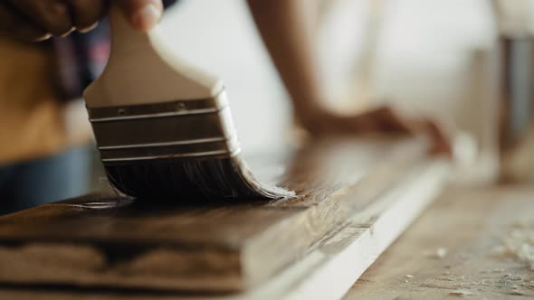 Close up video of painting boards with a brush. Shot with RED helium camera in 8K alt