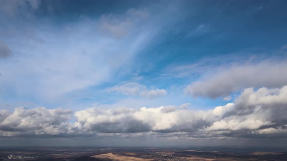 Aerial View From High Altitude of Earth Covered with Puffy Rainy Clouds Forming Before Rainstorm alt
