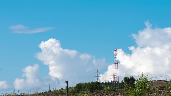 Movement of Cumulus Clouds Behind a Hill with a TV Tower on Top alt