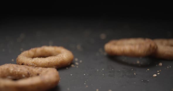 Onion rings close up slow motion studio, tasty fast food