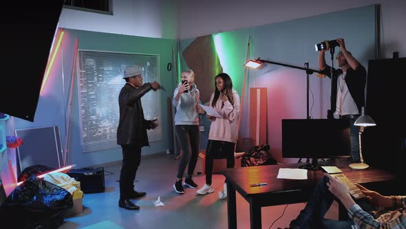 Film Studio Backstage: Some Woman Interrupting Preparation To the Film Shooting By Making Selfie alt