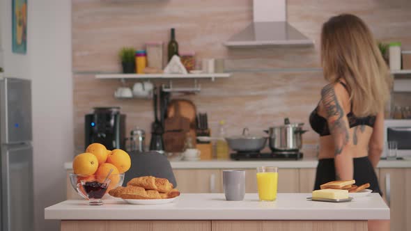 Lady in Lingerie Preparing Breakfast alt