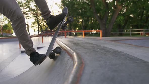 Skateboarder Doing a Tricks in a Concrete Skate Park Close Up Slow Motion alt