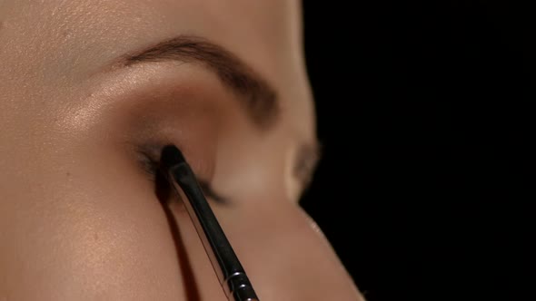 Woman Applying Make Up To Woman. Black. Closeup alt