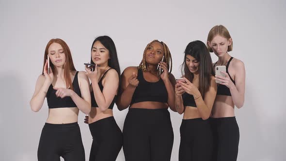 Portrait of Beautiful Diverse Fat and Skinny Models Using Smartphone