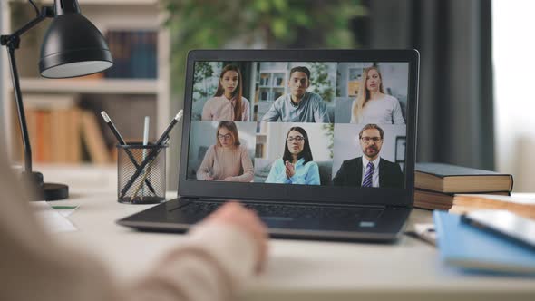 Woman Having Videochat with Coworkers