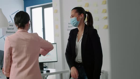 Business Woman with Face Mask Touching Elbow to Prevent Coronavirus Infection alt