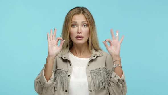 Slow Motion of Fashionable Caucasian Woman with Blond Hair Saying Okay Showing OK Gesture to Agree