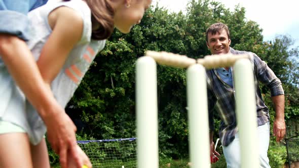 Happy family playing cricket alt