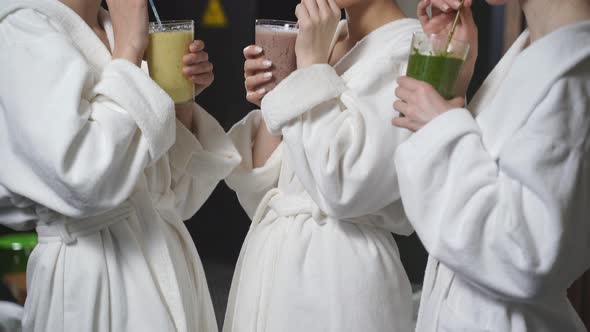 Young Three Women Drinking Juicy Detox Juice Beverage After Spa Treatment Having Rest Enjoying