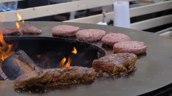 Slow Motion: Grilling Meat Steaks and Cutlets on Brazier with Hot Flame