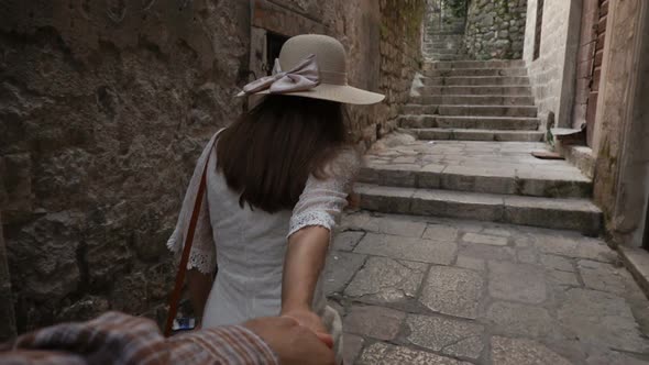 Young Woman Leading a Man To the Adventure in an Old European Town