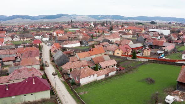 Aerial View Of Transylvanian Village In Sansimion, Harghita County, Romania With Distant View Of Ciu alt
