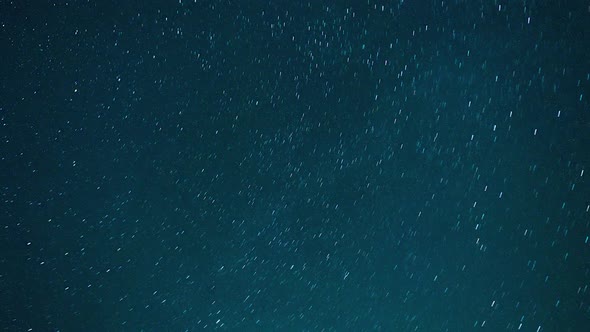 Stars and cosmos passing through colorful night sky time lapse alt