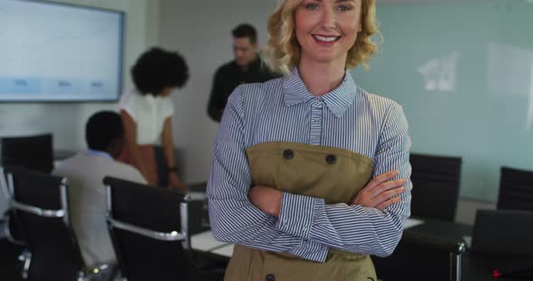 Portrait of caucasian businesswoman in meeting room looking to camera smiling alt