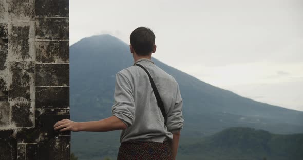 Close Up Truck View of a Man Standing Between the Gates of Heaven Black Stone Pillars in Pura alt