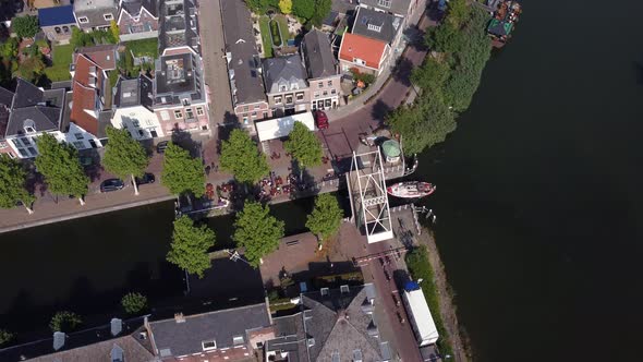 City Weesp in Holland topdown view at boat sailing trough city under opened bridge alt