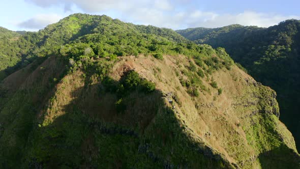 Beautiful Aerial Footage of the Grassy Top of the Mountain Under the Bright Sun. alt