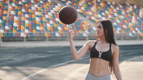 Young Sporty Girl Playing with a Sport Ball at a Stadium alt