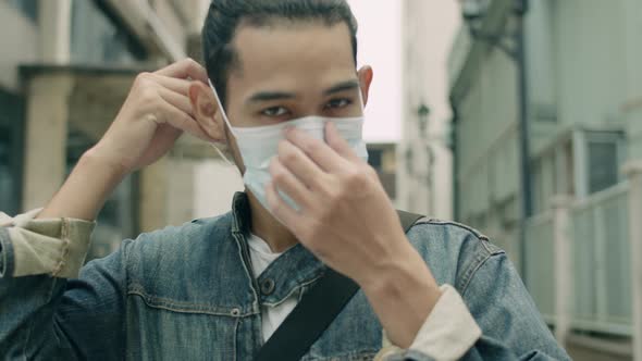 Portrait of an Asian man wearing a face mask against air pollution and covid-19 pandemic.