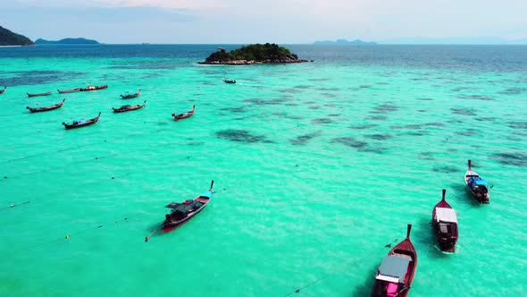 Aerial view of Long tail boats floating on the beautiful transparent sea at Ko Lipe in Thailand