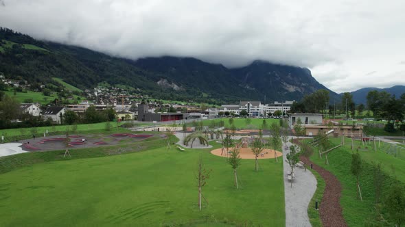 Playground for Children in Liechtenstein Among the Mountain Valley Aerial Vew alt