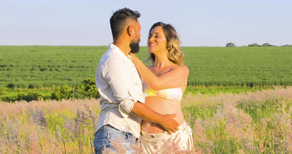 Latin husband holding pregnant wife's belly. a new life on the way. Fix shot. alt