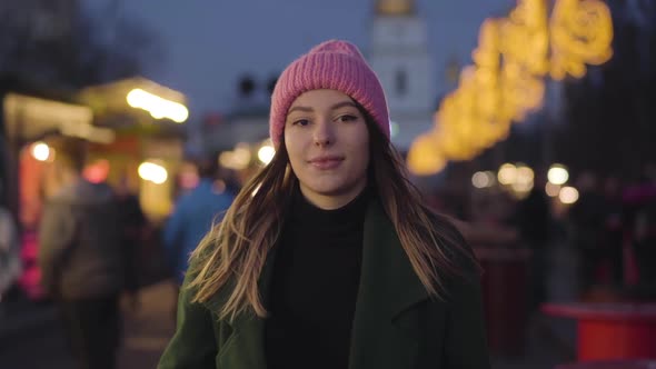 Camera Approaching To Young Charming Caucasian Woman Standing on City Market and Smiling. Portrait alt