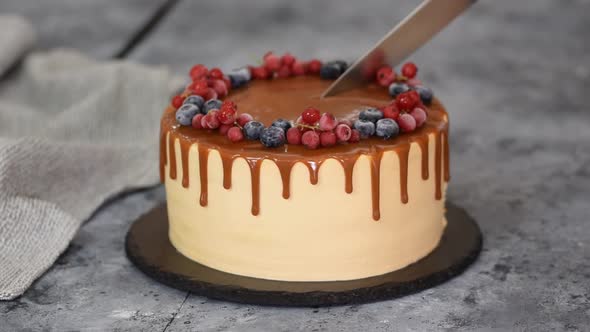 Female Hands Cutting a Birthday Berry Cake