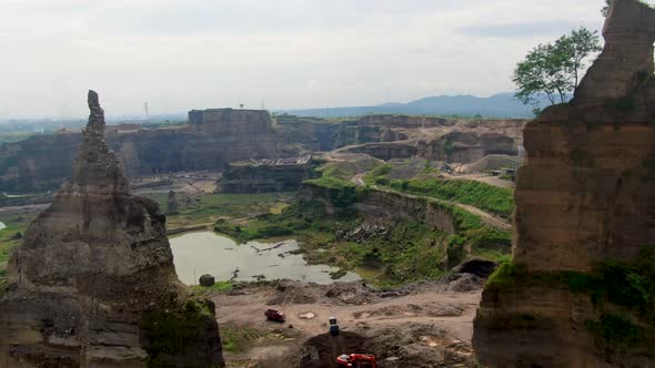 Aerial view of open pit Brown Canyon sand mine between to rock cliffs Indonesia alt