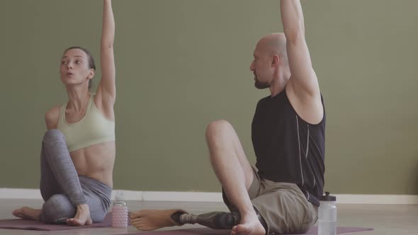 Man with Prosthetic Leg Training with Female Coach Indoors alt